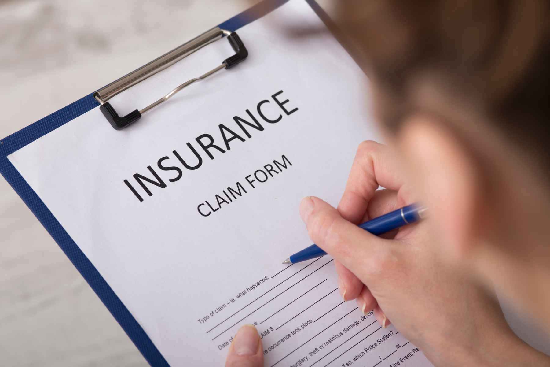 Professional movers wrapping furniture for moving insurance